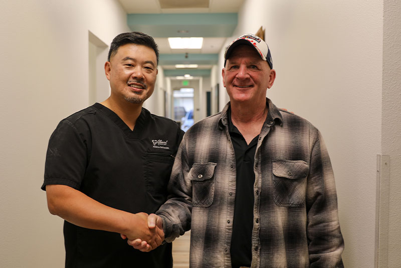Dr. park with patient smiling and shaking hands
